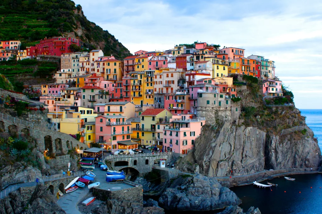 The new night train service winds through the coast of Liguria along stunning villages like Manarola in Cinque Terre where white and brown concrete houses can be seen
