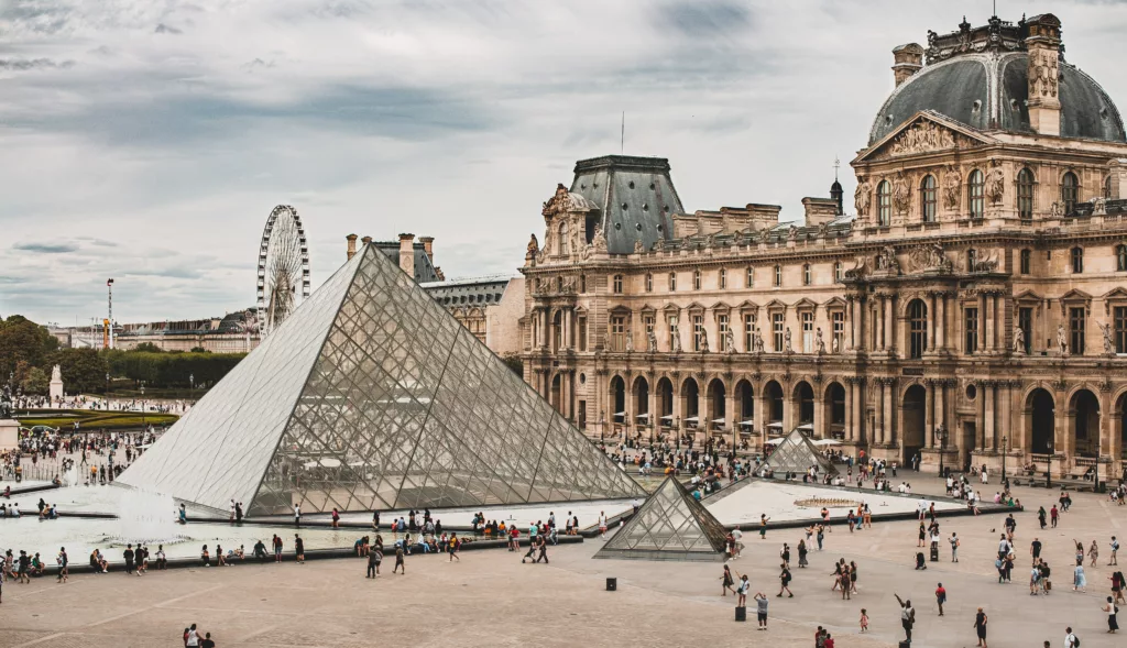 A view on Louvre and its famous pyramids, one of the most iconic photo spots in the world
