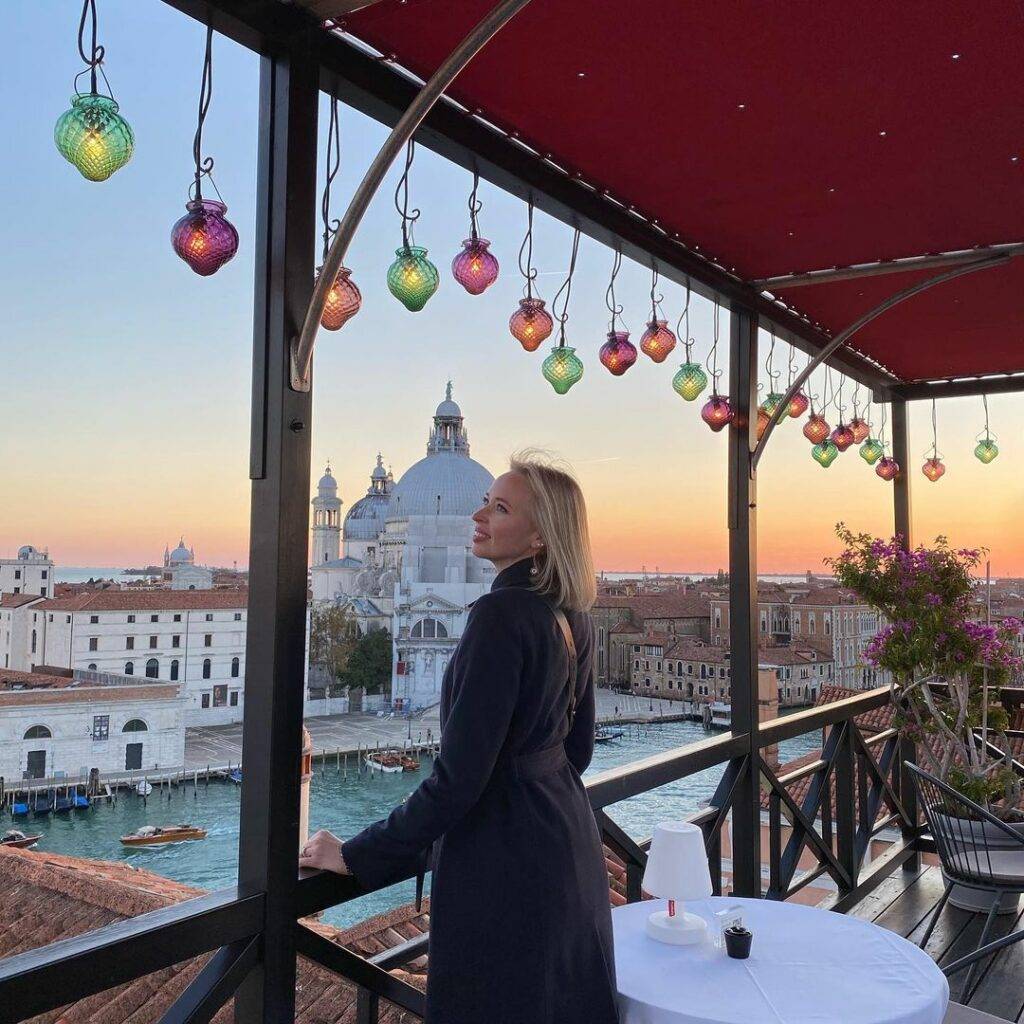 A woman poses for a photo at Settimo Cielo, one of Venice's best rooftop bars